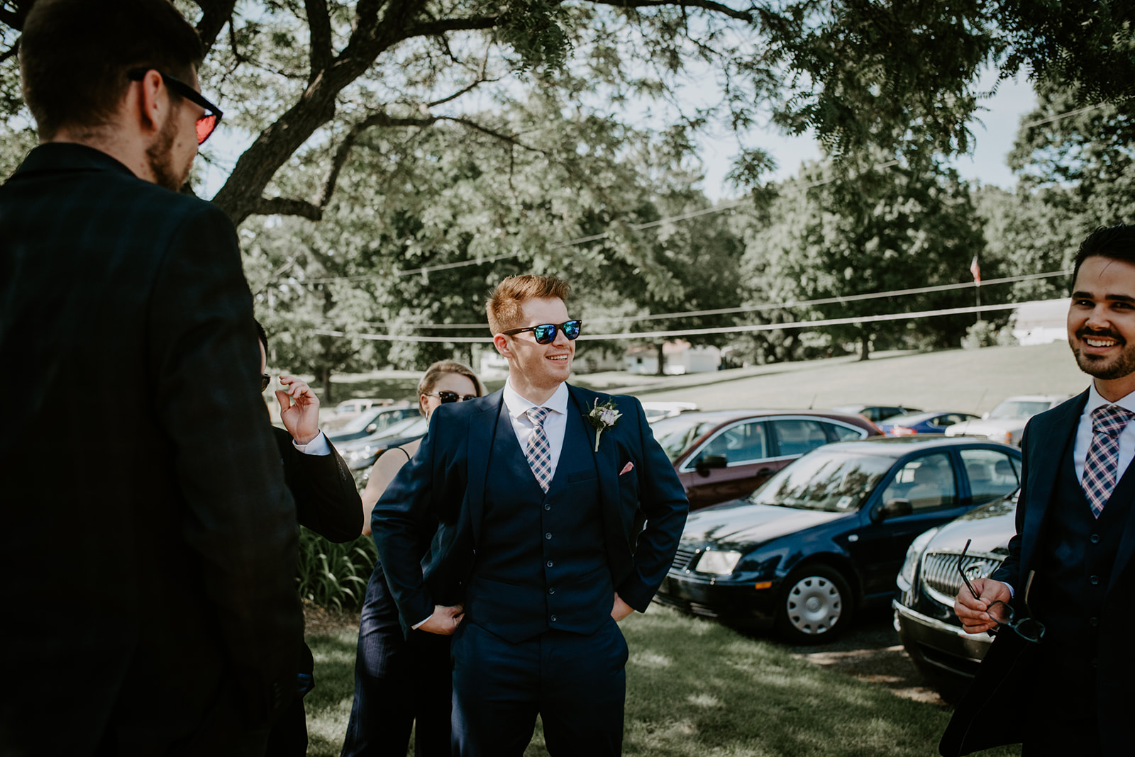 best man in sunglasses hanging out before entering the reception