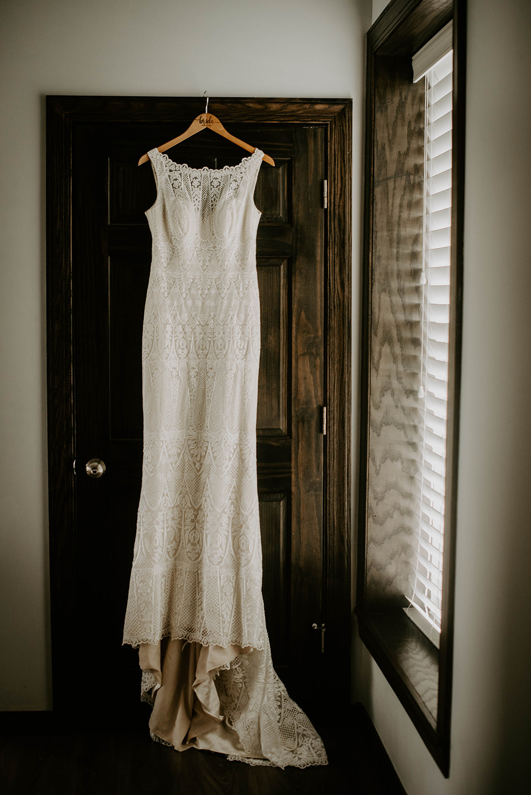 Wedding dress hanging from door. Michigan wedding photographer.