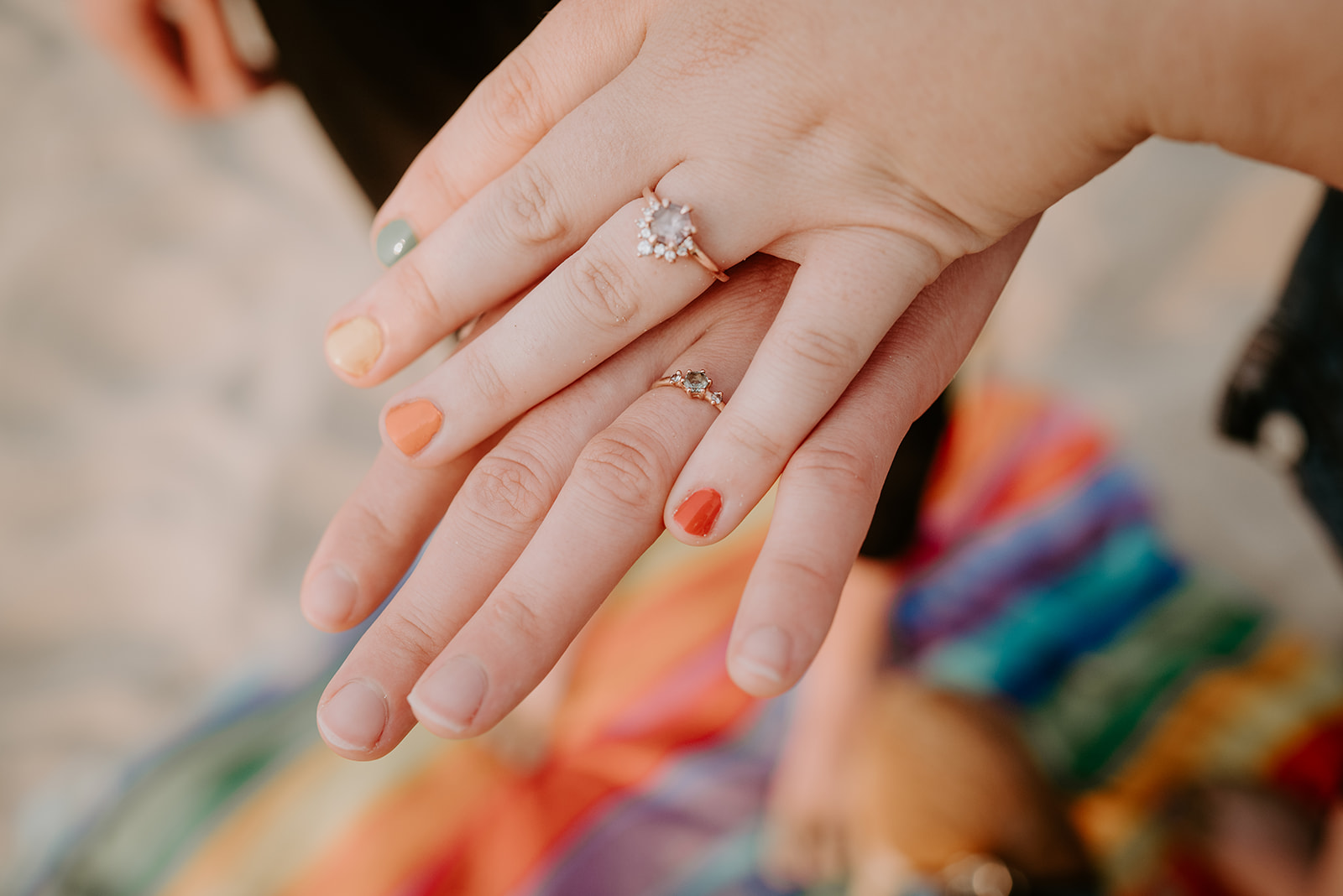 engagement rings, engagement session, Grand Haven City Beach, rainbow blanket