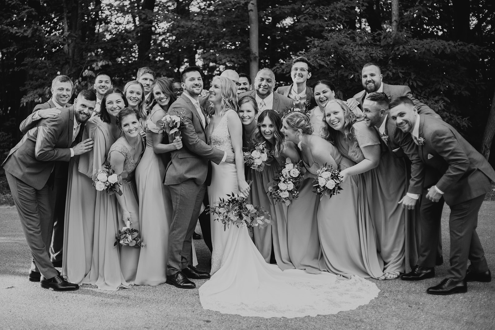 wedding party in grey and taupe wedding outfits at john ball zoo bissell treehouse photography by Liv Lyszyk
