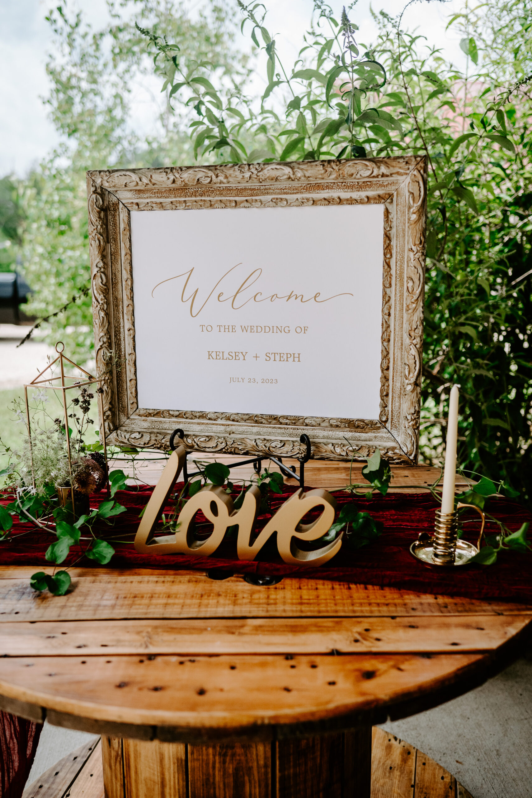 LGBTQ backyard wedding decor, wooden barrel decor, love sign, wedding florals, lgbtq wedding photographer in michigan Liv Lyszyk Photography