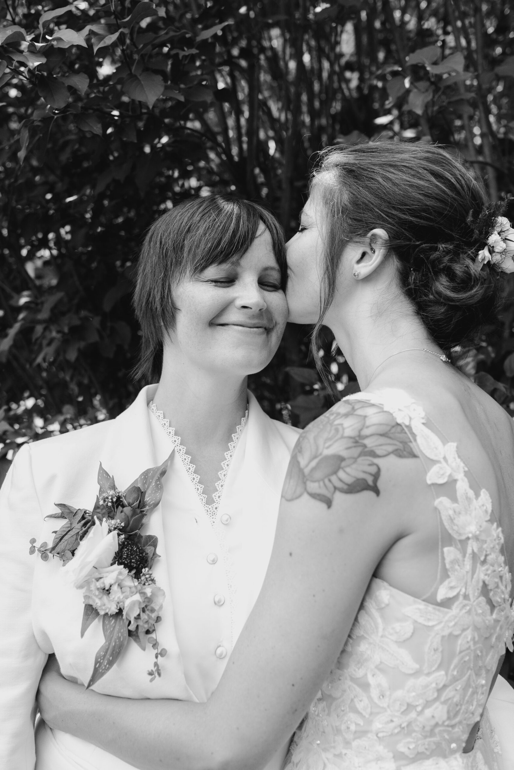 Black and white image of two brides kissing queer couple two brides queer wedding photography Grand Rapids based queer wedding photographer Liv Lyszyk photography based in grand Rapids grand Rapids queer couples photography for queer couples photography for brides