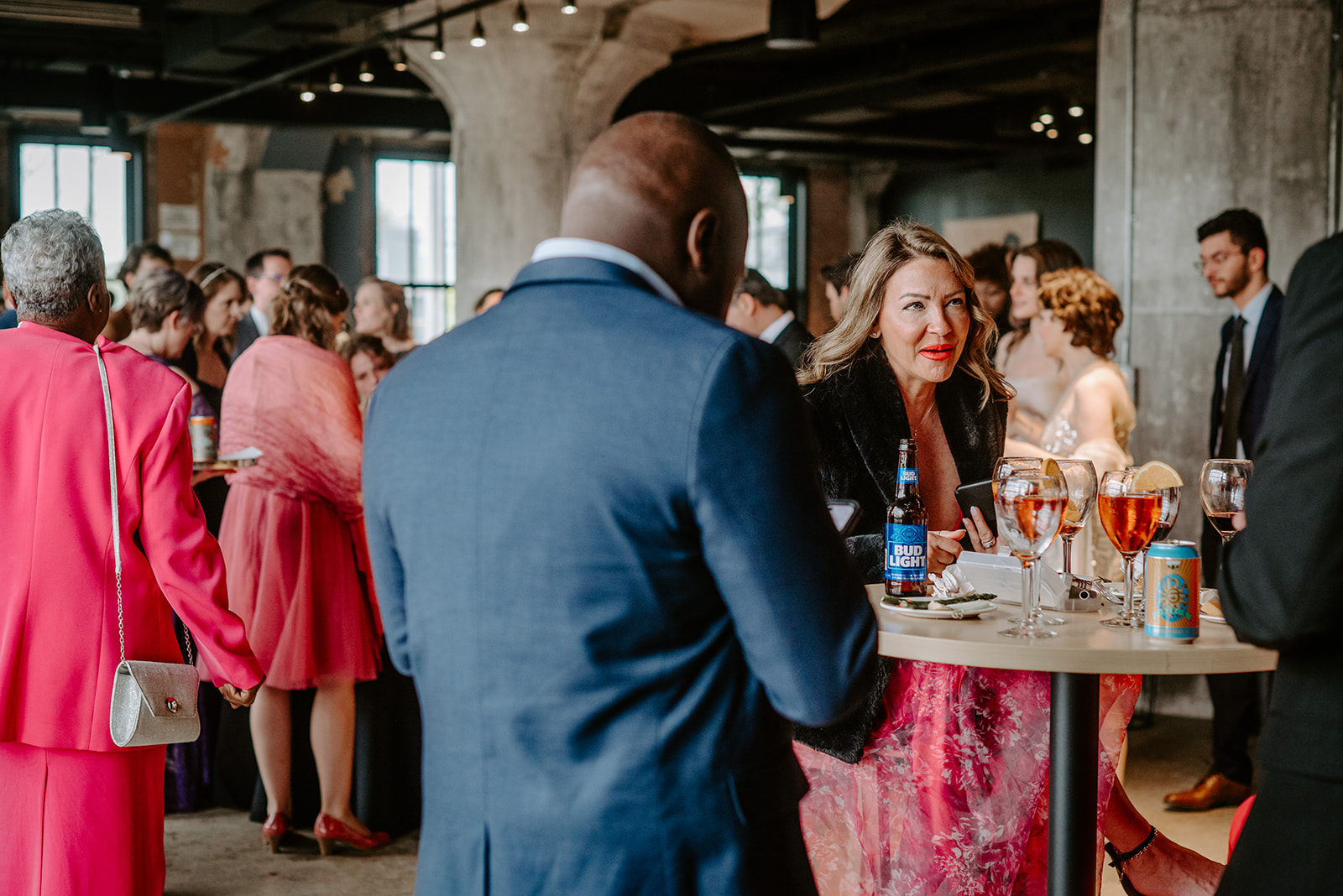 wedding guests mingling during cocktail hour at chroma detroit in michigan an elegant black tie wedding captured by Liv Lyszyk Photography a queer wedding photographer based out of Grand Rapids Michigan