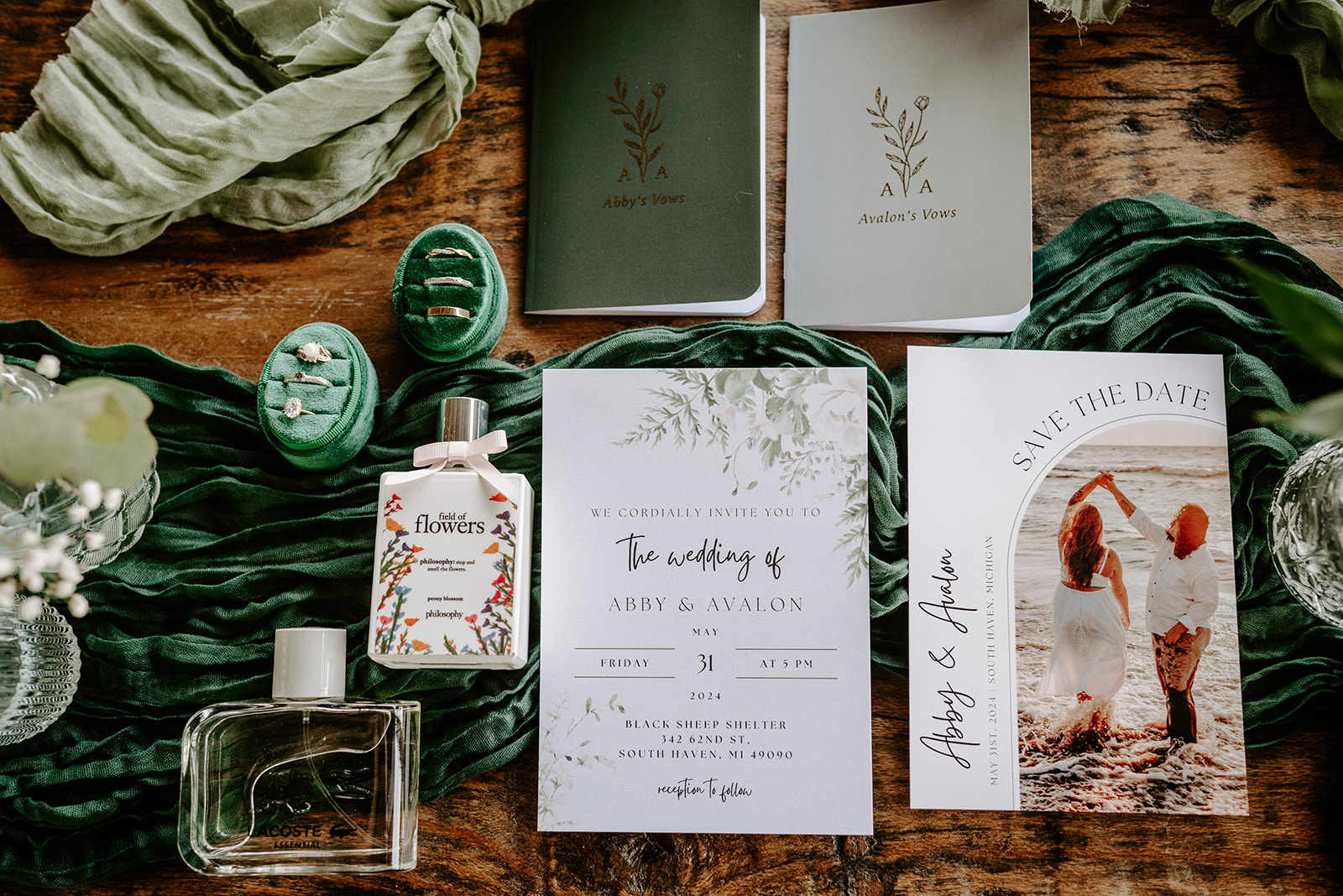 michigan spring DIY lesbian wedding at black sheep shelter detail shot with invitations florals perfume and personal vows