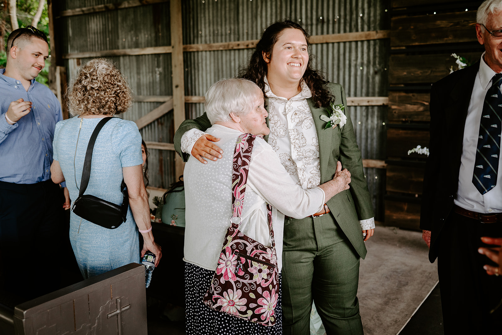 michigan spring DIY lesbian wedding at black sheep shelter bride hugging grandma