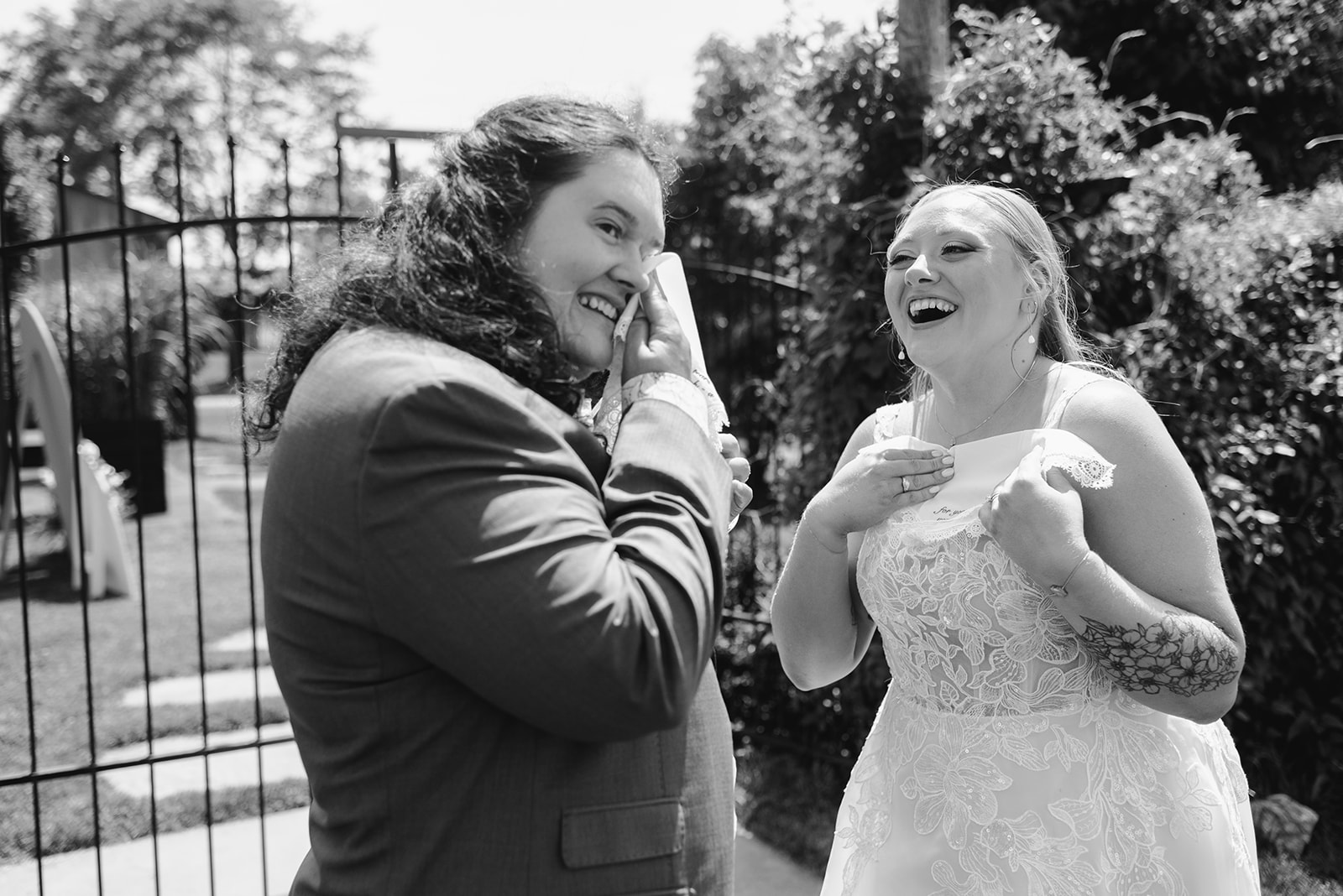 michigan spring DIY lesbian wedding at black sheep shelter black and white photo of two brides at first look