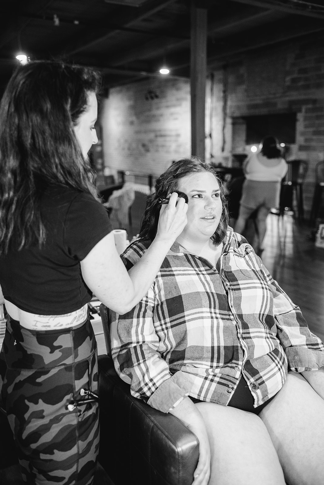 Black and white photo of bride getting ready at her downtown grand rapids wedding