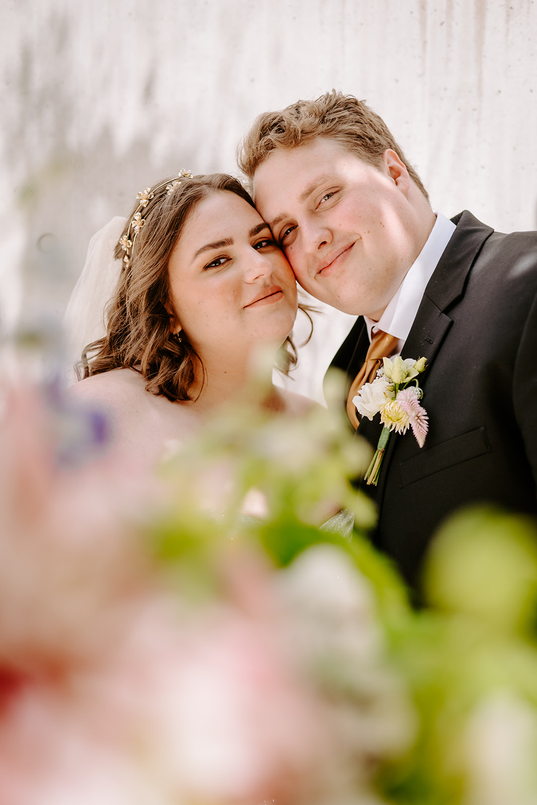 colorful flowers surrounding bride and groom on their wedding day in downtown grand rapids michigan
