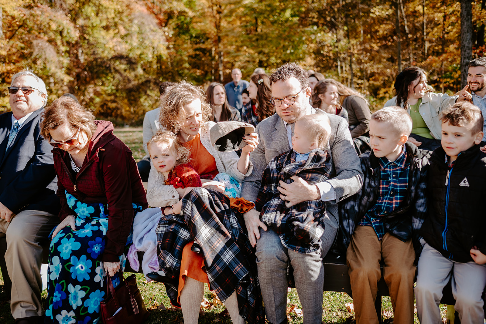 guests sitting wedding portrait  fall wedding at camp merrie woode by grand rapids wedding photographer Liv Lyszyk Photography