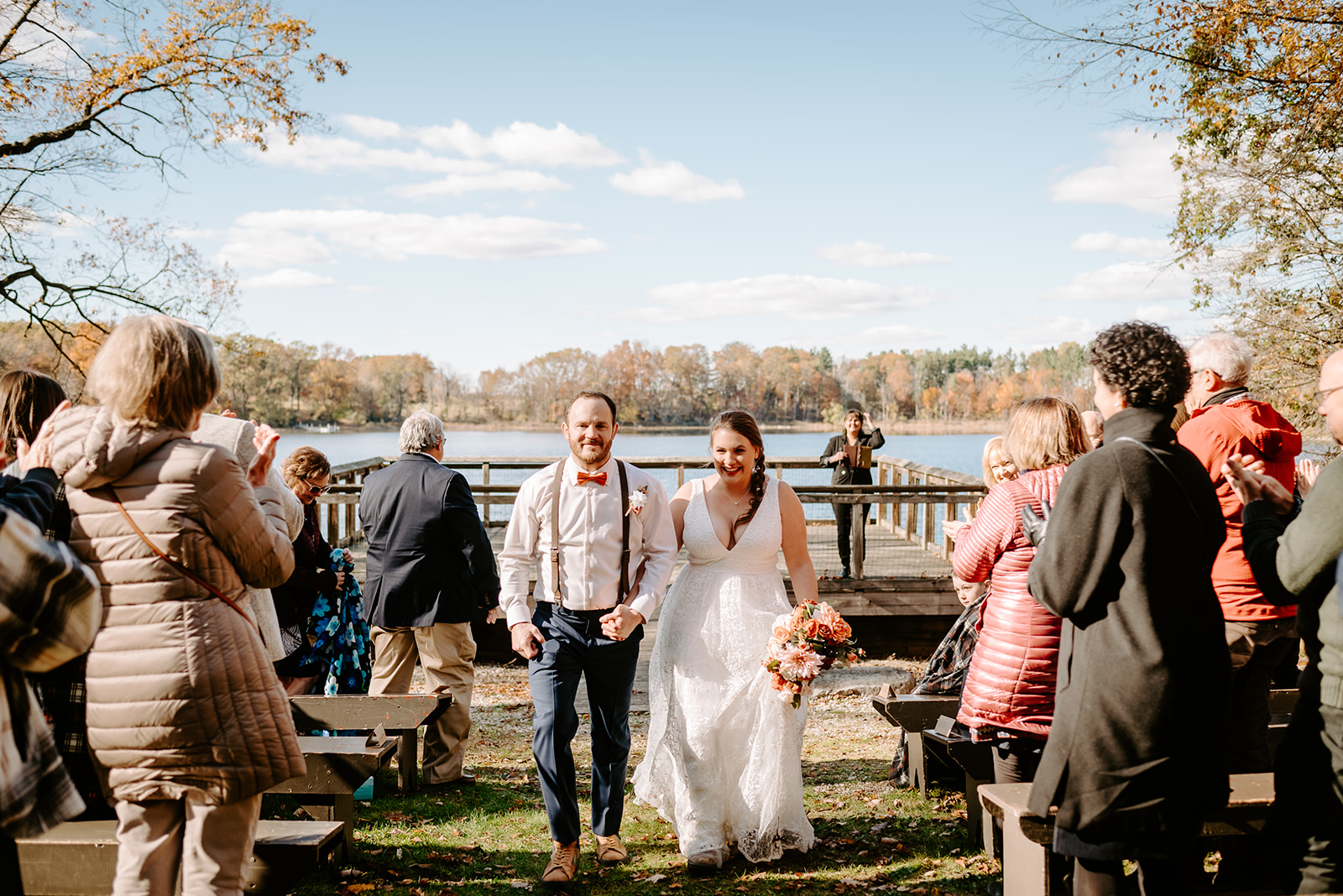 bride and groom walking back down aisle fall wedding at camp merrie woode by grand rapids wedding photographer Liv Lyszyk Photography