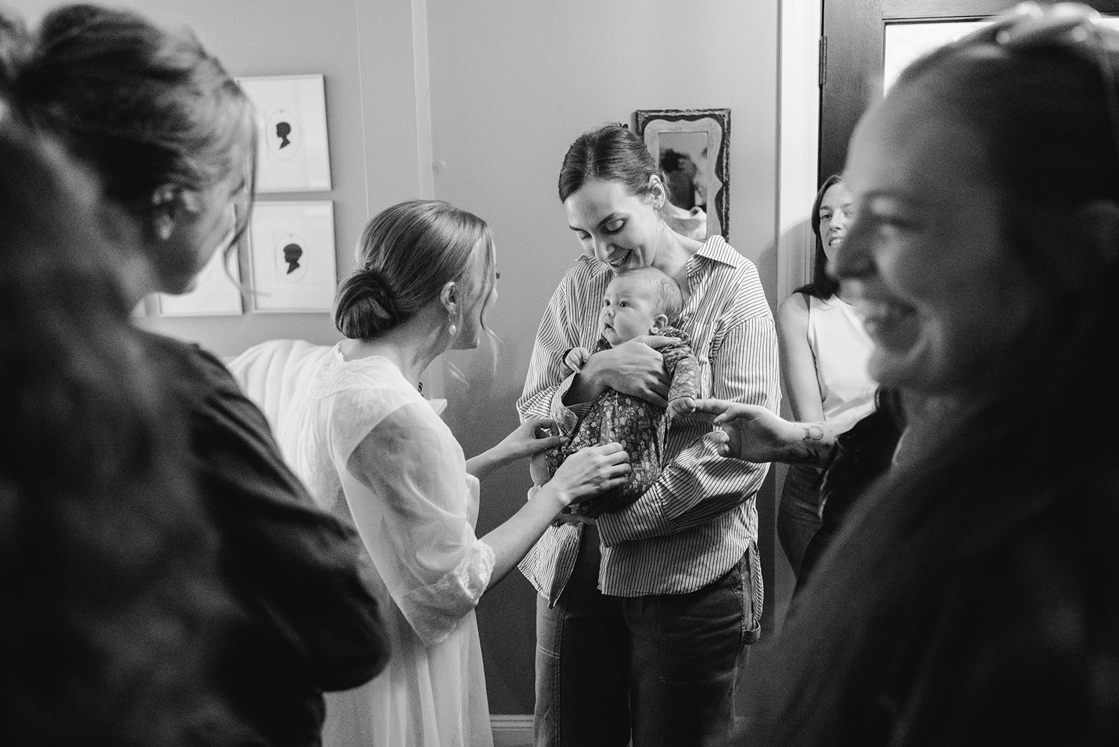 black and white image of bride talking to baby at greenhouse wedding at goldner walsh greenhouse in pontiac michigan by grand rapids and west michigan wedding photographer Liv Lyszyk Photography